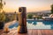 tower speaker on a balcony with a pool view at sunset