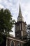 Tower of the St Botolph`s Aldgate church in London. Holy Trinity Minories.