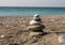 A tower of stones on a beach in Abkhazia - Zen as a feeling of calm and tranquility y Lasu sun and calm sea Black Sea