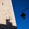 Tower with streetlamp and shadow