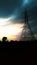 Tower in a village behind dark clouds