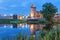 Tower an wall of Kolomna kremlin reflecting in water in the even