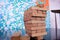 Tower of wooden blocks balanced on a single block on a office table. Business concept.