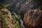 Towering canyons with a stream of water in between