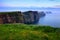 Towering cliffs of Moher at dusk, with rolling fog, Ireland