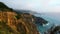 Towering, eroding cliffs hover above the Pacific Ocean`s blue waters at Big Sur