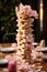 Towering Instability: A Shaky Jenga Tower on Vintage Tablecloth