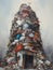 A towering mountain of trash spilling out of a single overflowing bin.. AI generation