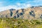 Towering moutains with desert mansion community in the deserts of arizona in a rural neighborhood with native cactuses