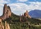 The towering red rock formations of the Garden of the Gods of Colorado Springs with Cheyenne Mountain in the background