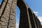 Towering sunlit arches of a railway viaduct, close up