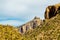 Towering sunny cliffs in the hillsides of sabino national park in arizona with saguaro cactuses and grasses in arizona