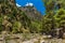 Towering vertical cliffs and a rocky, dry riverbed in the Samaria Gorge, Crete, Greece