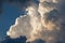 TOWERING WHITE BILLOWING CLOUD IN DARK SKY