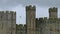 The towers of Caernarfon Castle in the rain , often anglicized as Carnarvon Castle, is a medieval fortress in Caernarfon