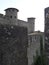 Towers of citadel between stone wall with blue sky and clouds