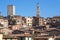 Towers and stone houses of Siena, Tuscany. Tile roofs and brick structures in Italy. UNESCO World Heritage Site
