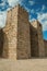 Towers and stone walls facade at the Castle of Trujillo