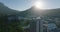 Town development and Lions Head mountain against bright sun. Forwards fly above buildings in City Bowl. Cape Town, South