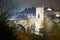 Town with gate on bridge in night. Besalu