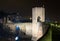 Town with gate on bridge in night. Besalu