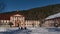 Town hall and catholic rectory located in old buildings in town center in winter with snow-covered square.