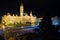 Town hall and square on a dark midnight after rain, blurred car lights on road, long exposure image of Gyor city