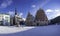 Town hall square during sunny winter snowy day in Riga, Latvia. View of covered in snow House of the Blackheads and Roland`s