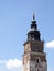 Town Hall tower, blue cloudy sky as a background. Cracow, Main Market Square famous landmarks. Postcard like shot, sunny day