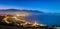 The town of Kaikoura, New Zealand. This was shot from a hill. It was dusk and the sky turns deep blue. The city lights are bright