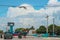 Town square of Yucatan Mexico fishing village with truck and car and motorcycles and bikes parked beautiful sky church with bell b