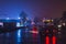 Town street with cars at night with mist