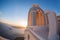 Town of Thira on the island Santorini, white church against colorful sunset in Greece