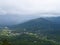 A Town in Valley among Mountains with Clouds in Sky - Natural Monsoon Landscape