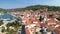 Town of Vela Luka on Korcula island church tower and coastline aerial drone footage