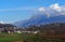 Townscape of the village of Buja, near Udine in Italy, under the beautiful scenery of the Julian Alps on an early spring day
