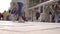 Townspeople are walking over street and city square in sunny spring day, view from ground, blurred shot