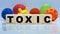 TOXIC inscription on wooden cubes on the background of various forms of viruses, medicine concept