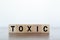 Toxic Word written on wooden cubes