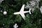 Toy airplane on the background of Christmas tree branches with Christmas balls and a snowflake. New Year Travel Concept