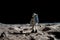 The toy of the astronaut stands on the moon\\\'s surface