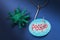 Toy bacteria, tag with text and a large hook. Concept on the topic: humanity is held hostage by the coronavirus