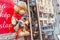 toy bear armed with AK-47 hangs at the entrance to an unusual souvenir shop or museum