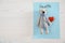 Toy bear, heart, sheet of paper with word HEALTH and space for text on wooden background, top view.