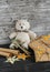 Toy bear, homemade Christmas gifts in Kraft paper, candy n wooden surfaces.