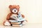 Toy bear reading an interesting book, showing that even read toys. the concept of baby learning