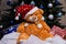 Toy bear wishes you a Merry Christmas. New Year. Christmas decorations, toys, gifts. Souvenirs for the new year. Christmas