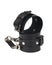 Toy black leather handcuffs isolated on the white background