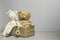 Toy box full of baby kid toys. Container with teddy bear, wooden rattles, stacking pyramid and wood blocks on light gray