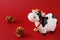 Toy bull with golden fir cones on a red background. Symbol of the Chinese New year 2021. Christmas concept .